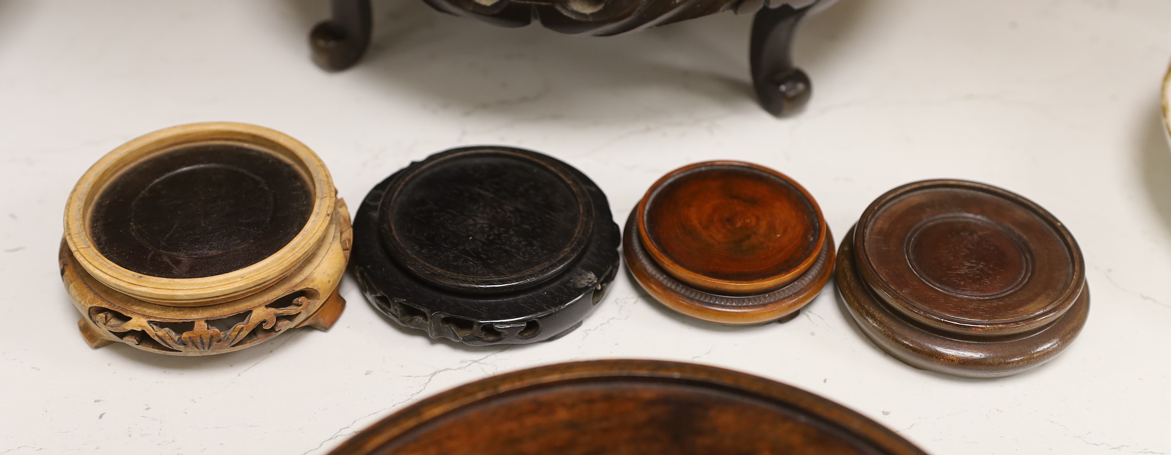 Two large Chinese or Japanese hardwood stands and four others, largest 11cm high